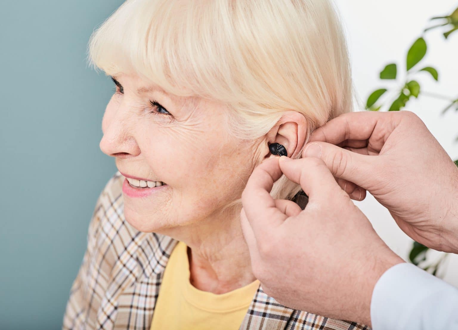 Senior woman getting fitted for a hearing aid.