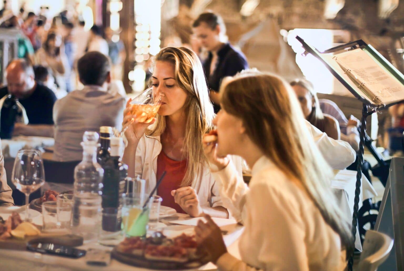 Friends dining out at a busy restaurant.