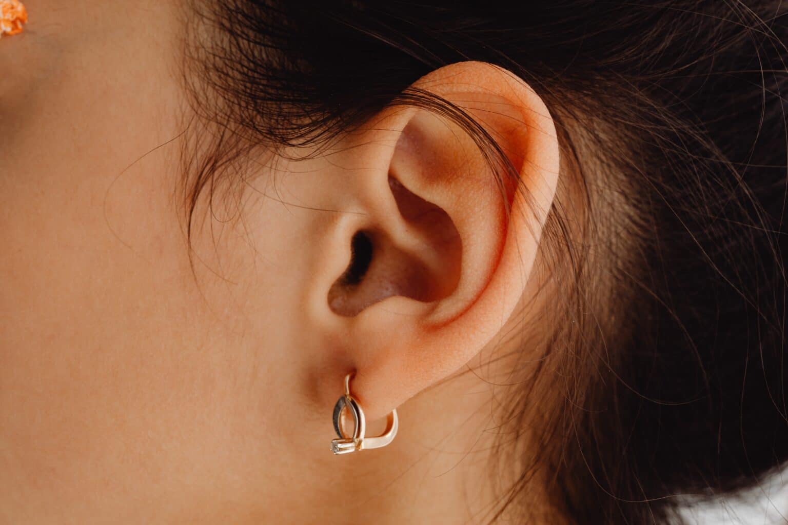 Close up of a woman with her earlobe pierced.