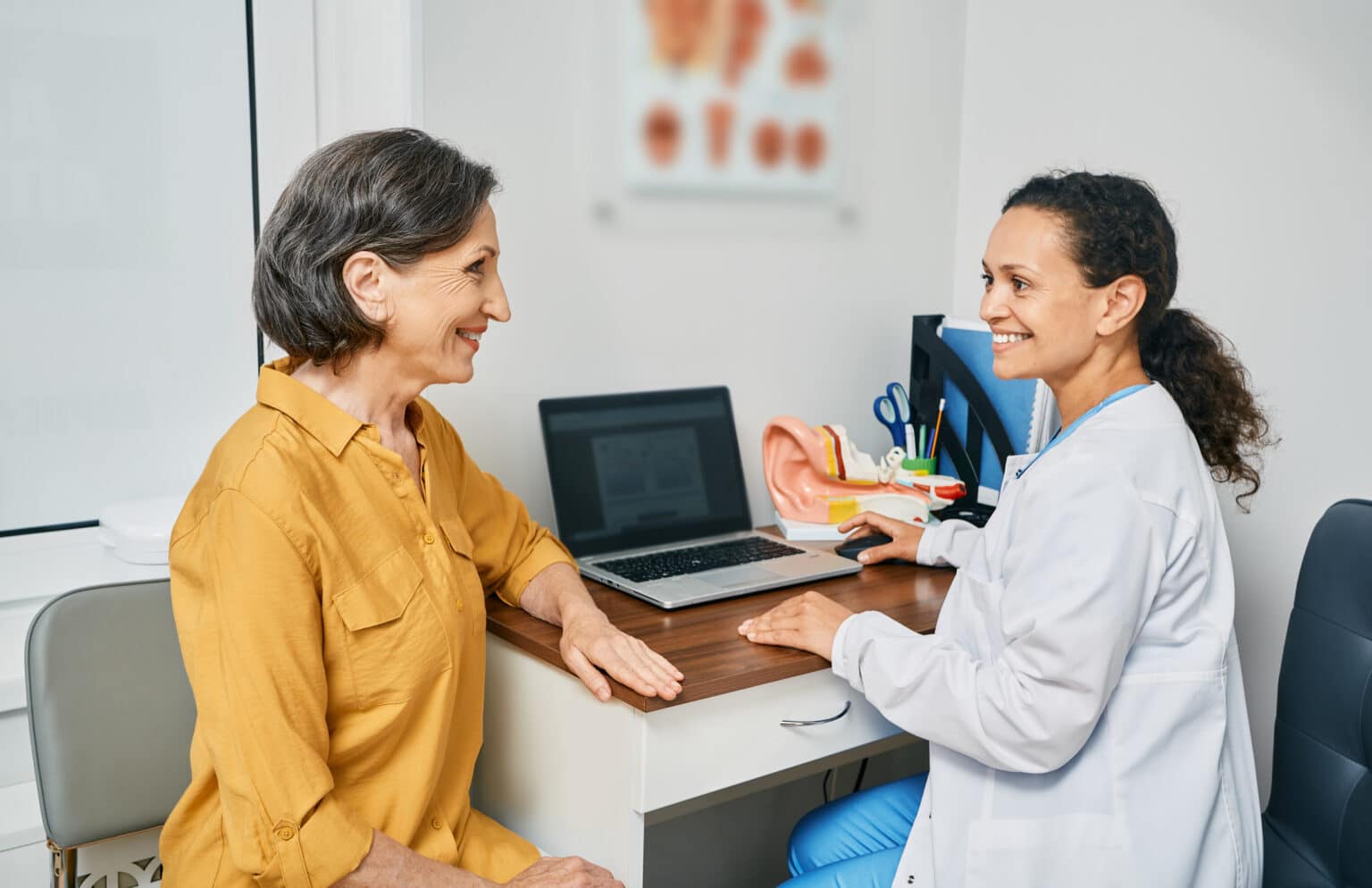 Woman consulting with an audiologist about hearing loss.