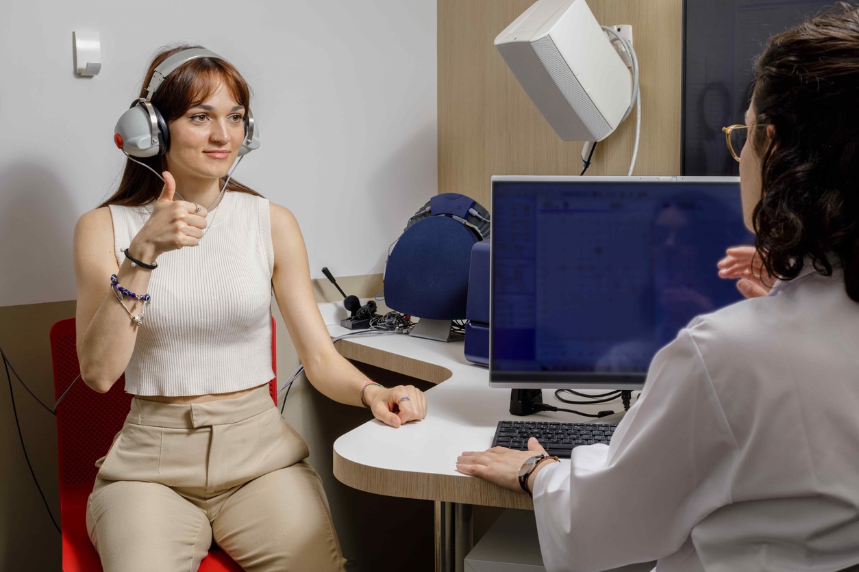 Young woman taking a hearing test.