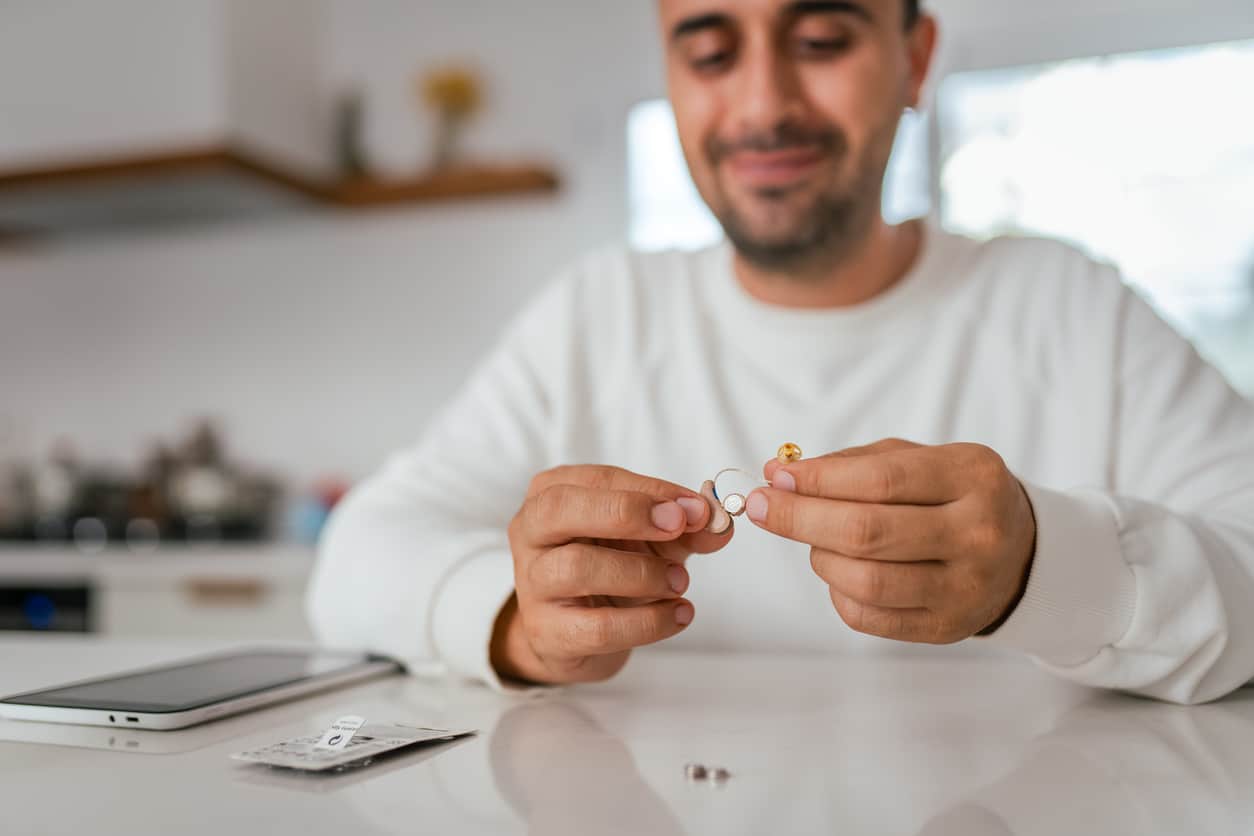 Man holds hearing aid